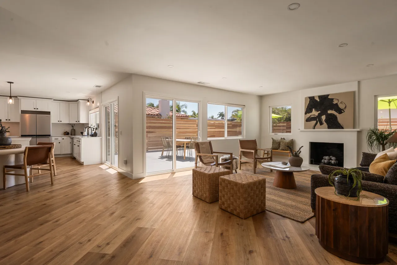 Great room open to the kitchen and dining area, with wood floors and doors to the patio, Oceanside home