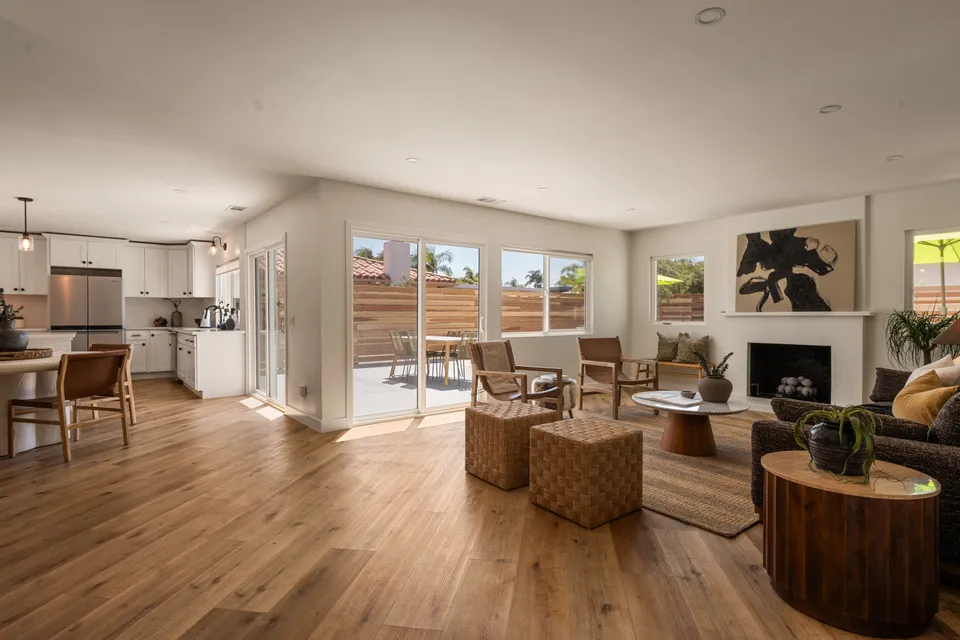 Great room open to the kitchen and dining area, with wood floors and doors to the patio, Oceanside home