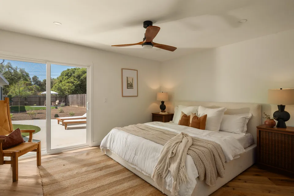 Primary bedroom with a ceiling fan and sliding doors to the backyard, Oceanside home