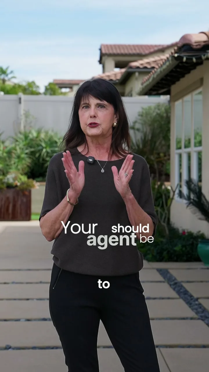 An agent filmed beside a pool for a video on launching a listing
