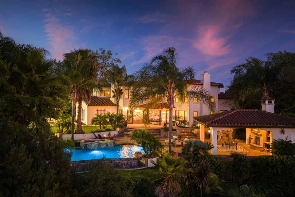 Gardens, pool and home at twilight