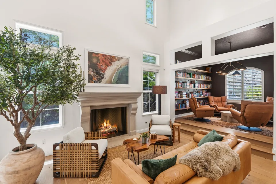 Living room with a fireplace and a library nook