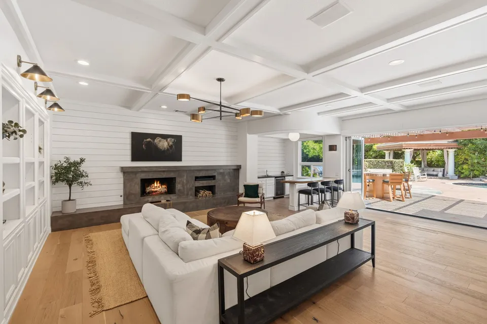 Family room with a coffered ceiling, open to the patio