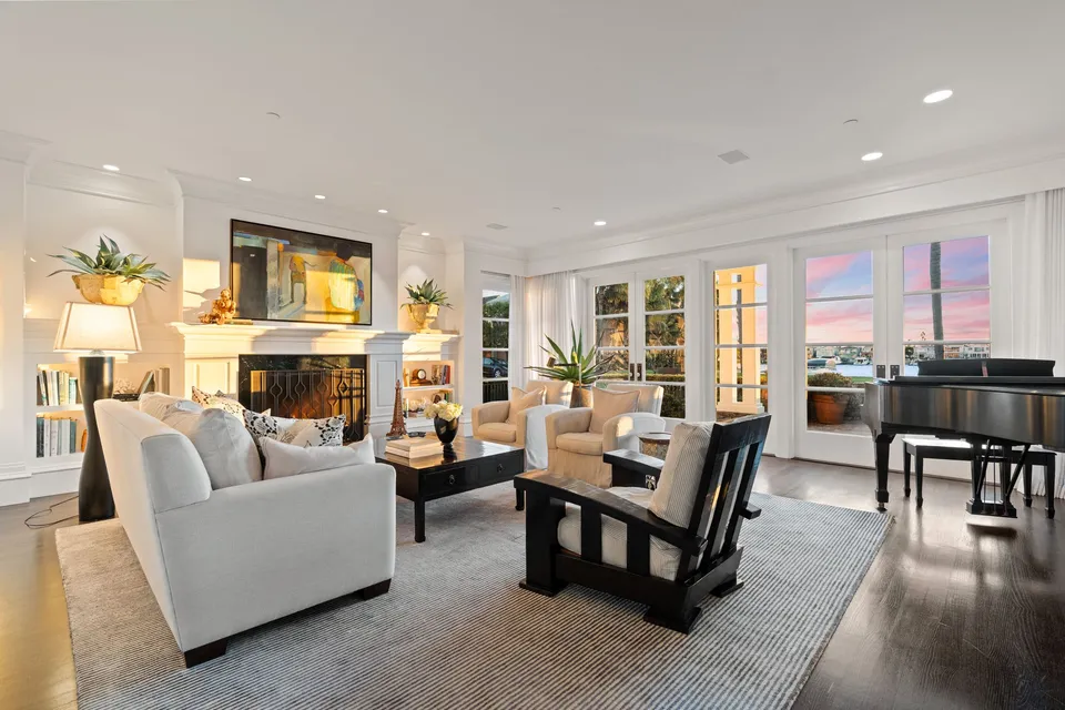 Living room with a grand piano and windows to the bay