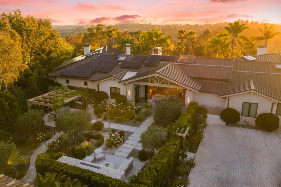Aerial photo of the home and gardens at sunset