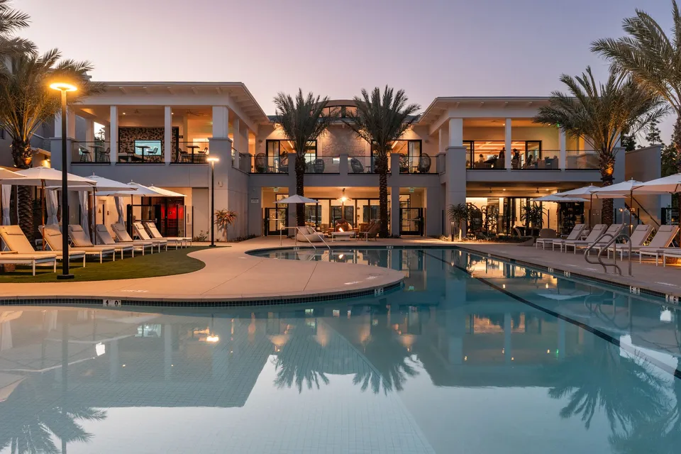 Pool and clubhouse at dusk